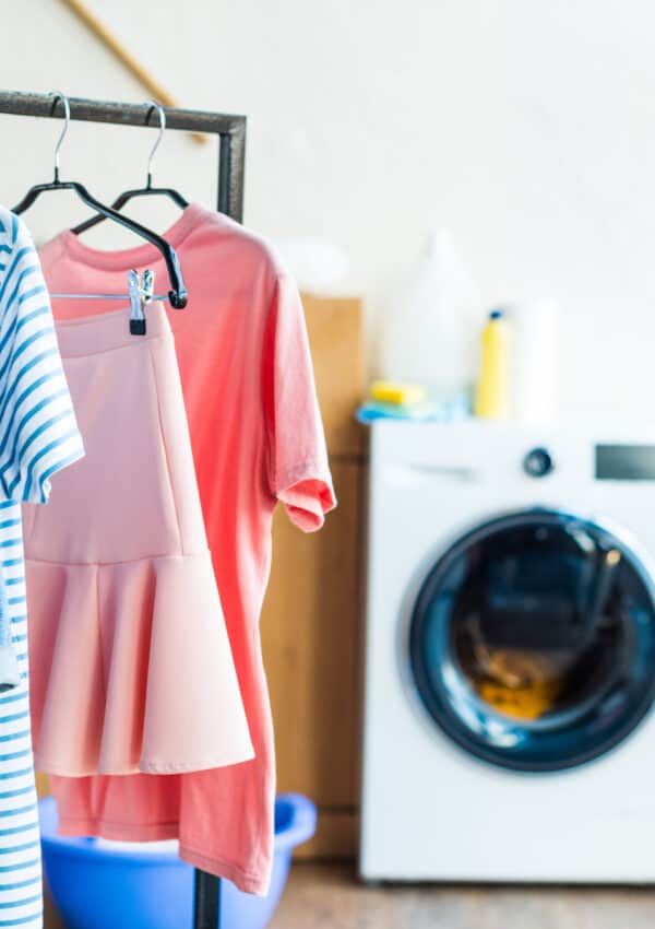 Clothes machine with peach, blue clothes hanging