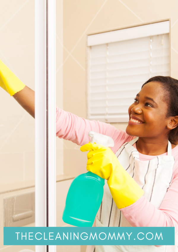 African American Woman Cleaning Glass Shower Doors