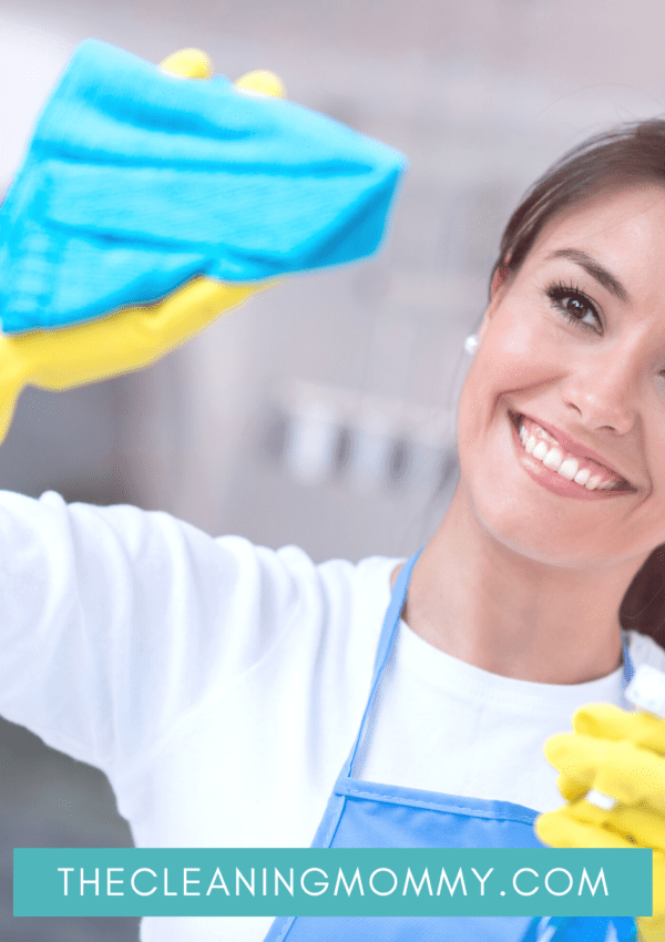 Pretty hispanic woman cleaning window with yellow gloves, blue cloth