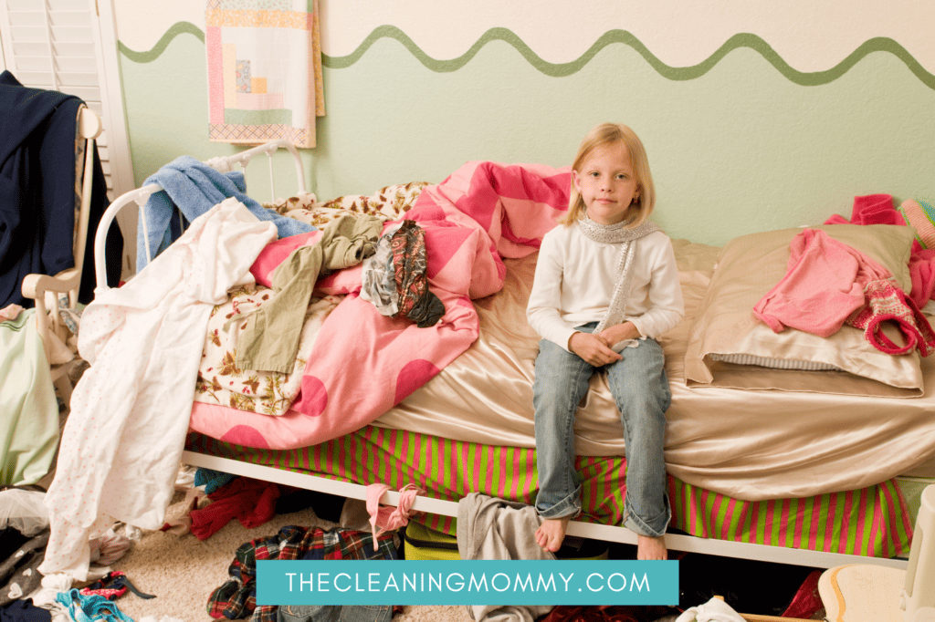 Kid sitting on bed surrounded by clutter