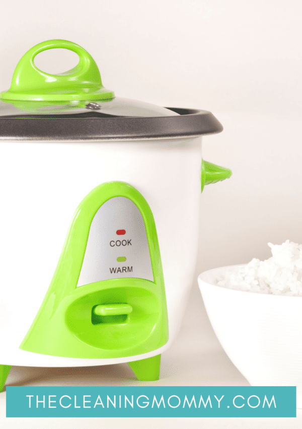 White and green rice cooker sitting on kitchen countertop