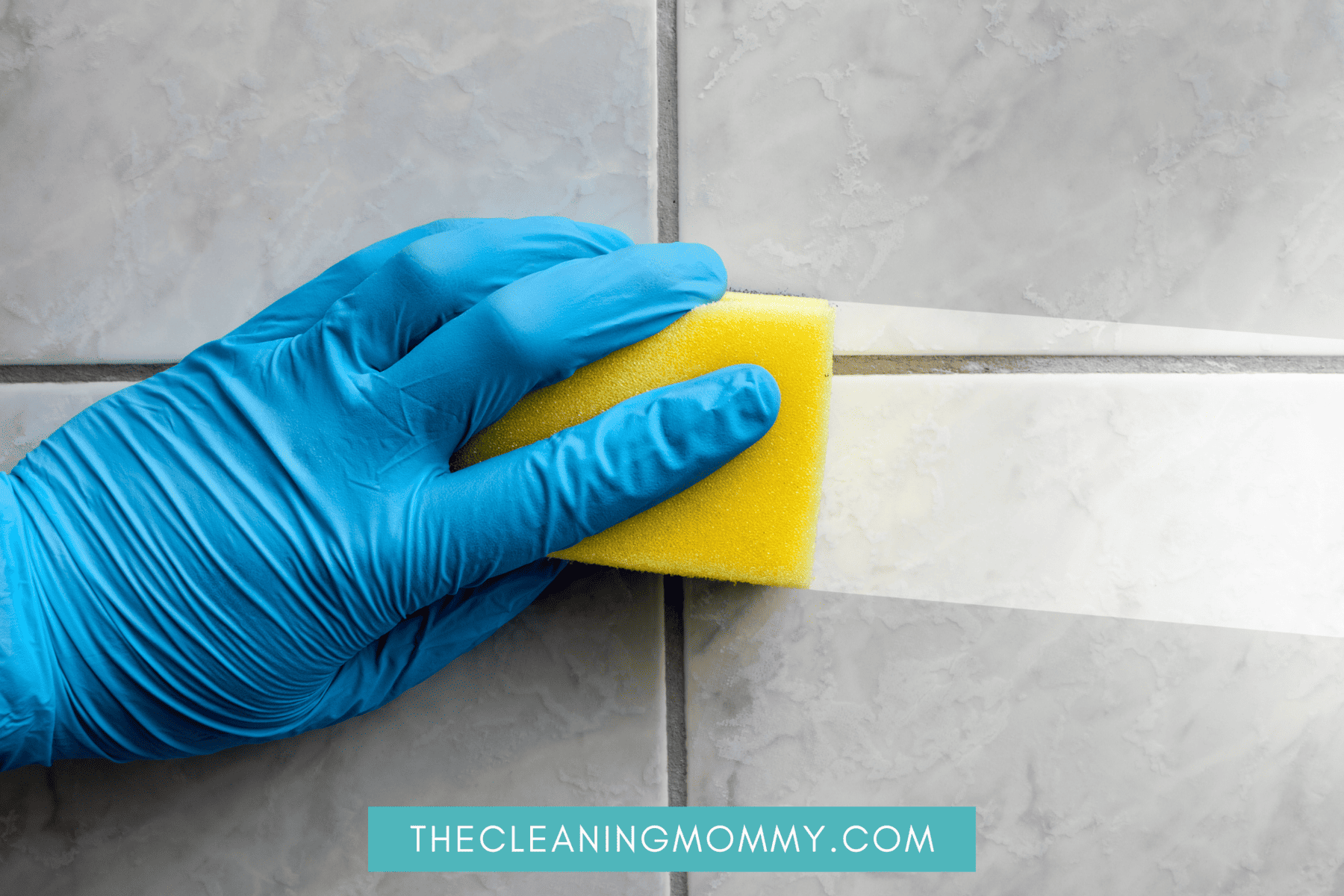 Blue gloves washing stain on bathroom wall with yellow sponge