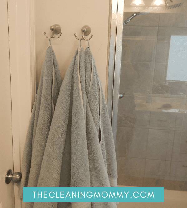 BAthroom with neatly hung teal towels