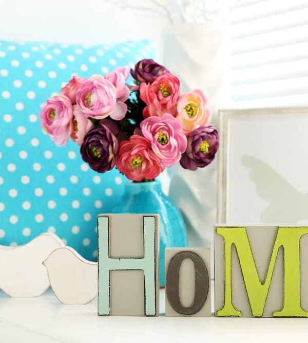 Home sign in colorful letters with pink flowers