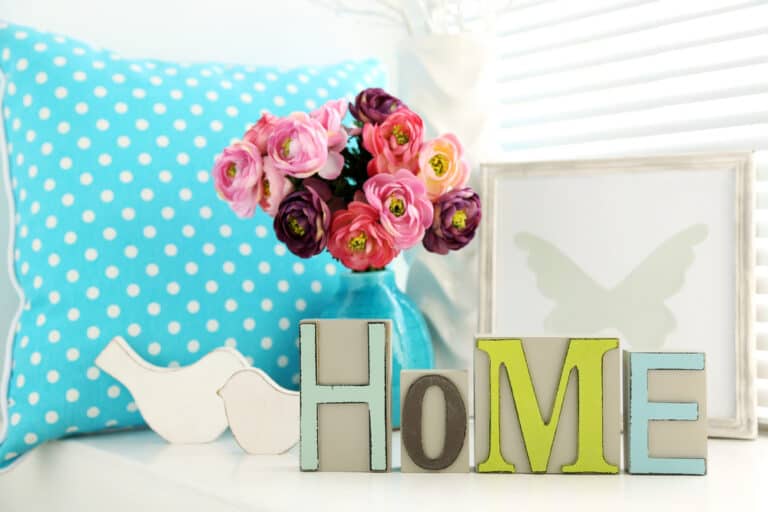 Home sign in colorful letters with pink flowers